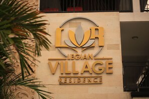 A building sign for Legian Village Residence.