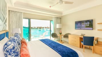 Una camera d'albergo con un letto, una scrivania, una TV e vista sulla piscina.
