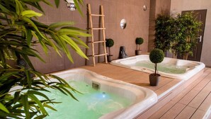 A spa area with two hot tubs, wooden flooring, and potted plants. - Grand Hôtel d’Orange, BW Signature Collection (Orange)