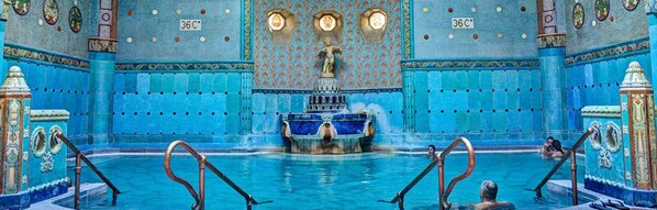A large indoor pool with ornate blue tiles and a central fountain. - Hotel Clark Budapest - Adults Only (Budapest)