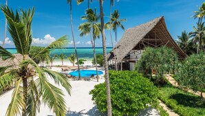 A resort with a pool, palm trees, and a beach. - Zanzibar Magic Boutique Hotel (Matemwe)