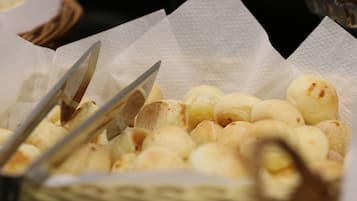 A basket of bread rolls on a table.