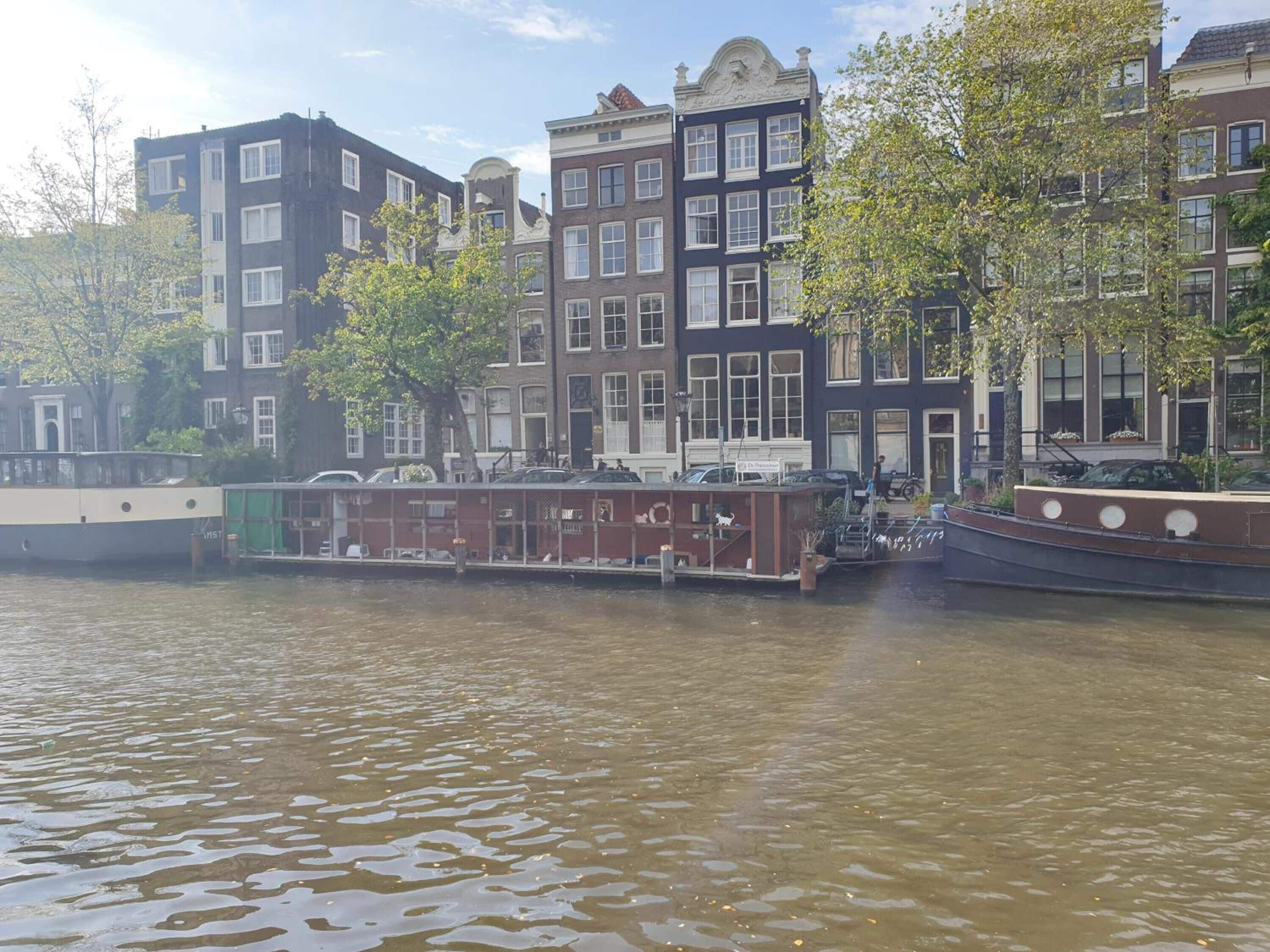 A canal with traditional buildings and a boat docked along the water.