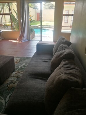 Cottage, Pool View, Garden Area | Living area | Flat-screen TV - Naisar Holiday Home & Cottage Primrose (Germiston)