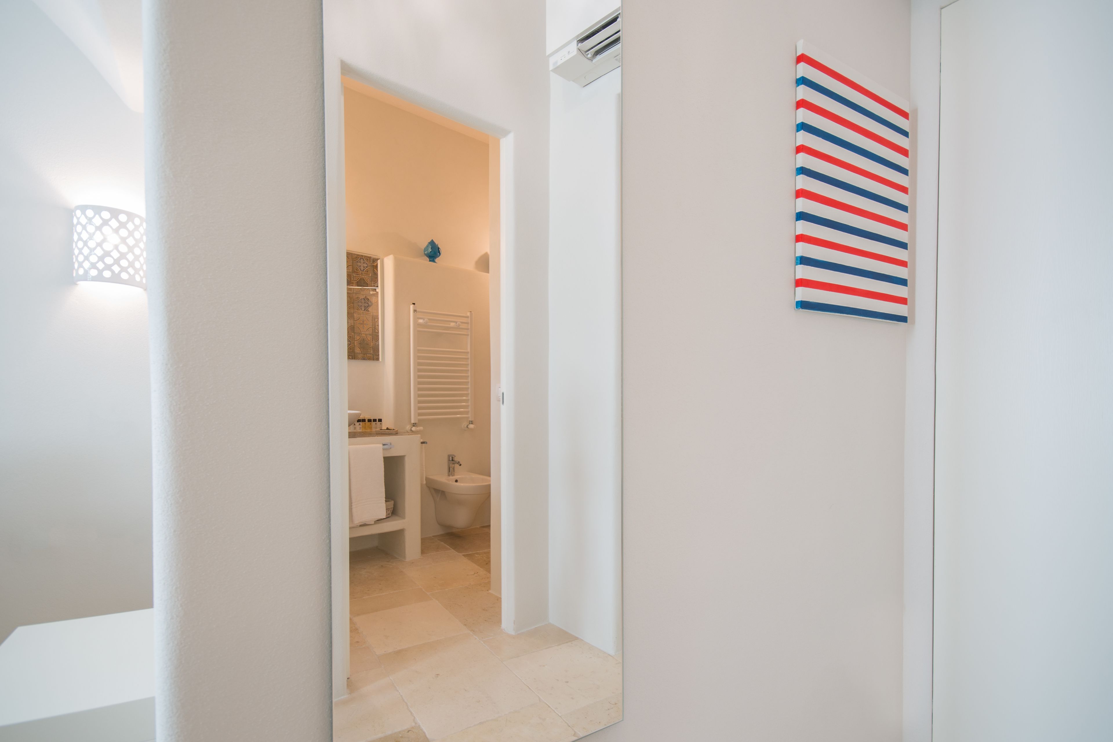 A modern bathroom with a toilet, bidet, and sink.