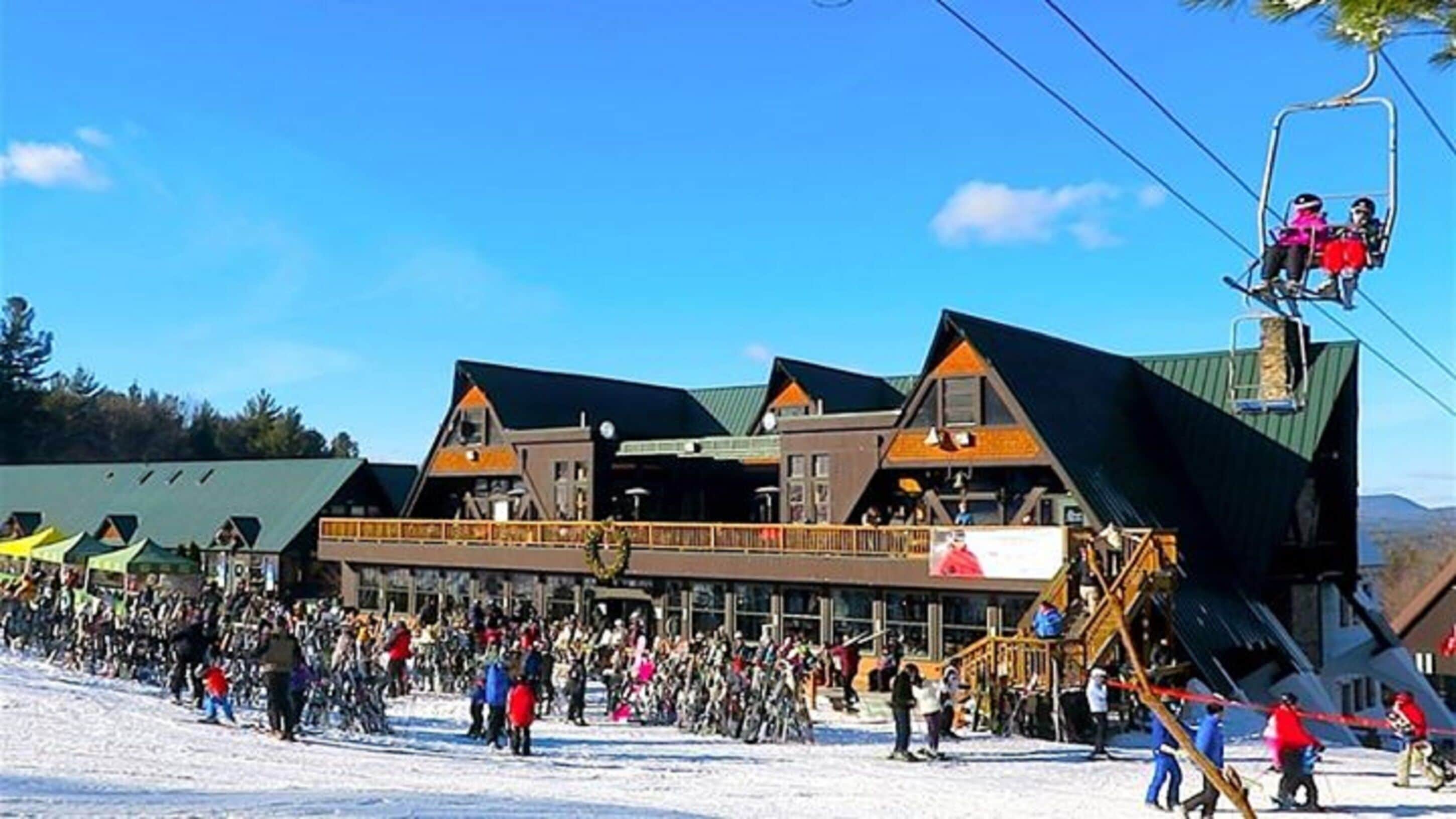 A ski resort building with multiple levels and a ski lift.