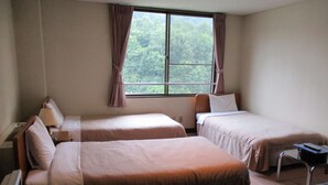 A hotel room with two beds, a desk, and a window with curtains. - Panoramaland Kijimadaira (Kijimadaira)