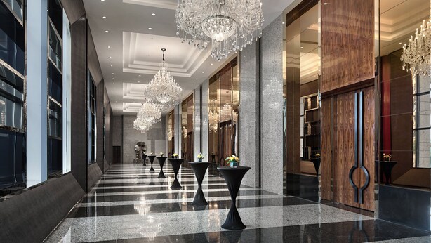 A spacious lobby with chandeliers, a checkered floor, and a wooden panel wall. - Crowne Plaza Shanghai Jinshan by IHG (Shanghai)