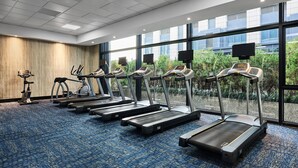 A gym with treadmills, stationary bikes, and a rowing machine. - Crowne Plaza Shanghai Jinshan by IHG (Shanghai)