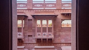 A traditional building with arched windows and intricate stonework. - Radisson Hotel Jodhpur (Jodhpur)