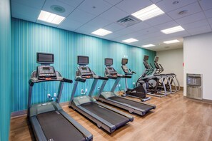 A fitness center with treadmills, ellipticals, and a water dispenser. - Holiday Inn Express & Suites Reedsville - State Coll Area by IHG (Reedsville)