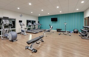 A gym with treadmills, elliptical machines, a bench press, and free weights. - Holiday Inn Express & Suites Dallas NW HWY - Love Field by IHG (Dallas)