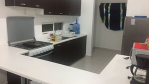 A modern kitchen with a gas stove, a dishwasher, and a coffee maker.