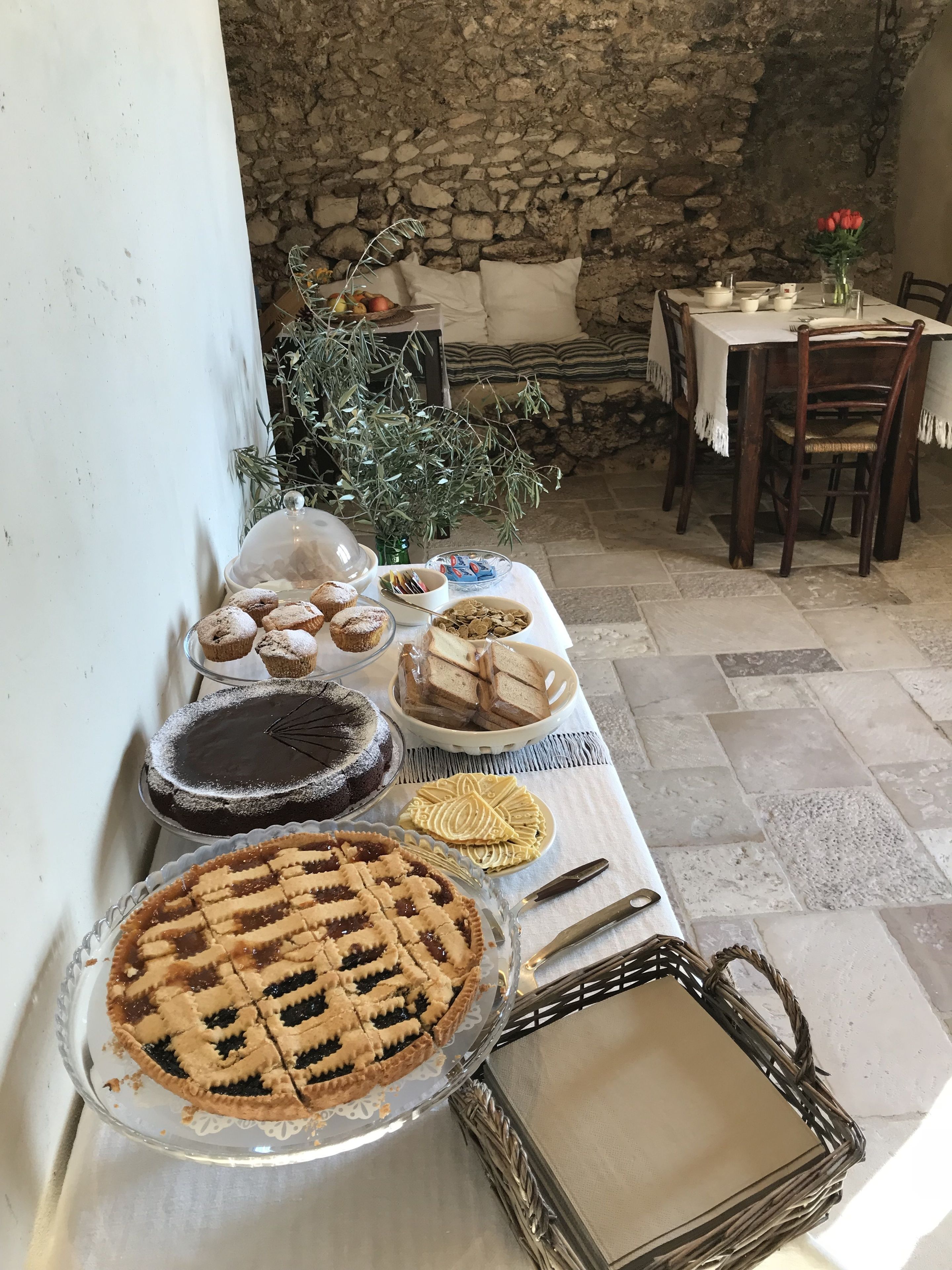 A table with various desserts and a wicker basket.