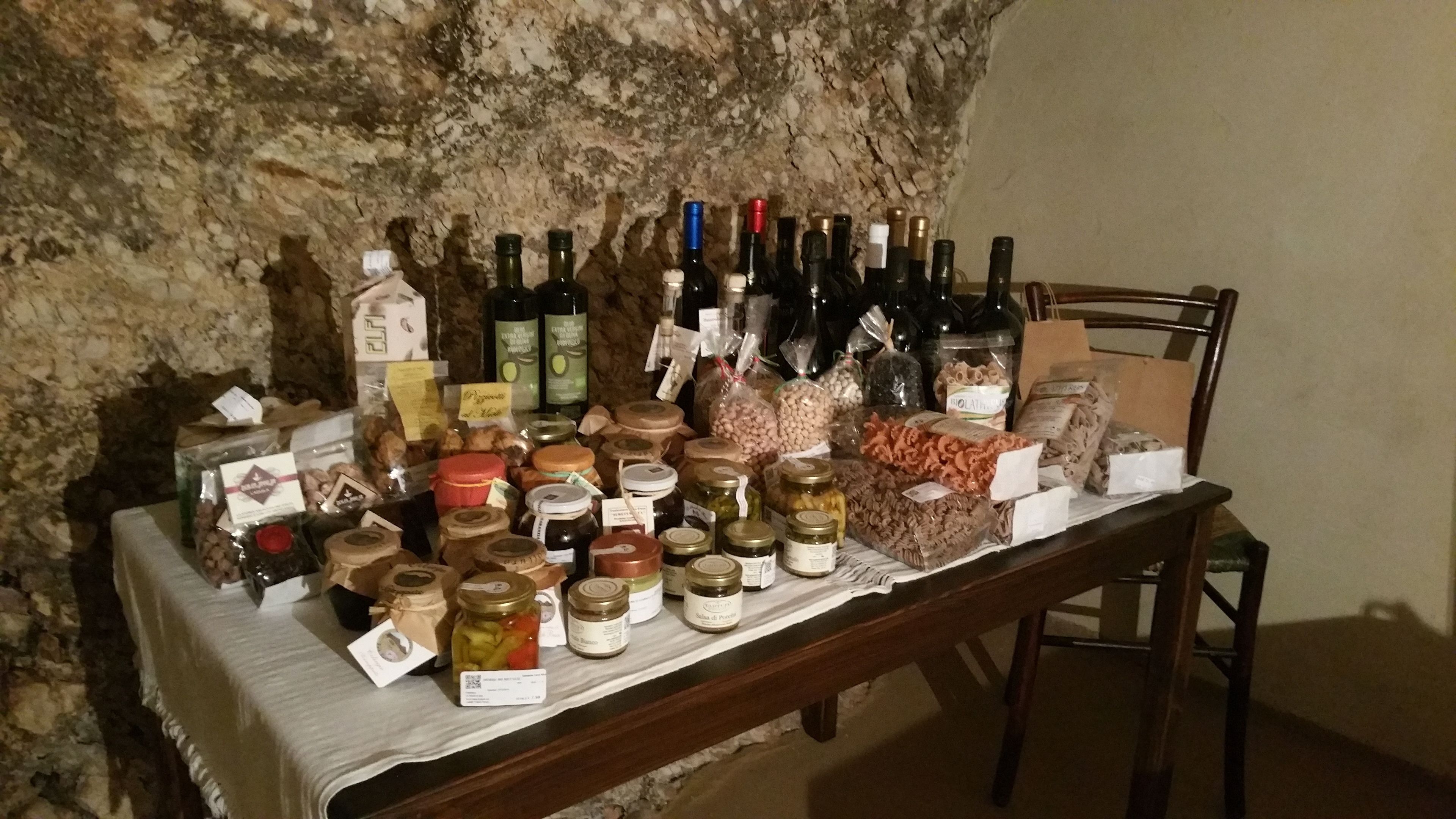 A table with various food items and bottles, likely for sale or display.