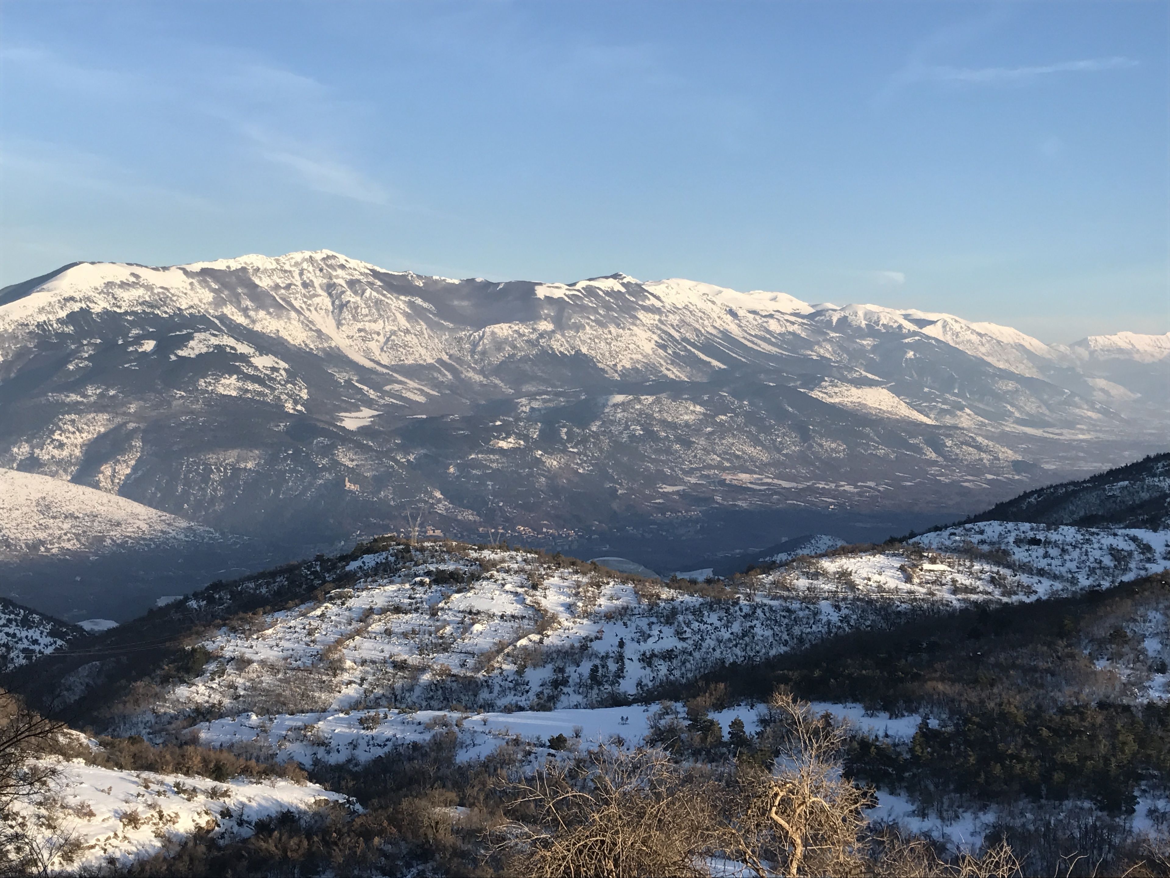 A mountainous landscape with snow-covered peaks and valleys.