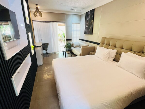 Standard Double Room | Living area | 42-inch LED TV with satellite channels, TV - Highlands Lodges and Apartments (Harare)