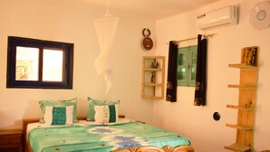 A bedroom with a bed, a window, a wall-mounted air conditioner, a shelf, and a hanging light fixture. - Hotel Mimosa - Hostel (Toubab Dialao)