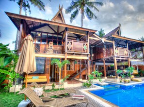 A two-story resort with a pool, outdoor seating, and tropical landscaping. - Apalagi Villas (Gili Air)