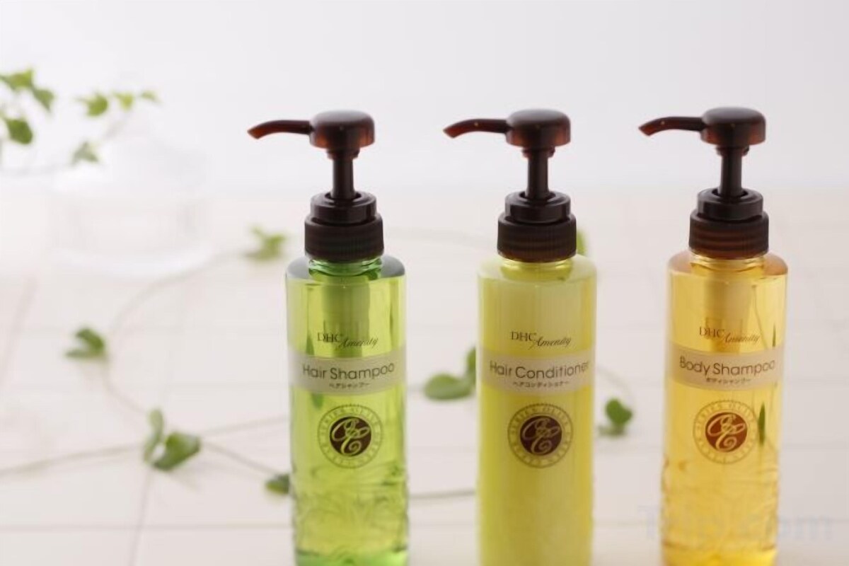Three bottles of hair and body shampoo with pumps.
