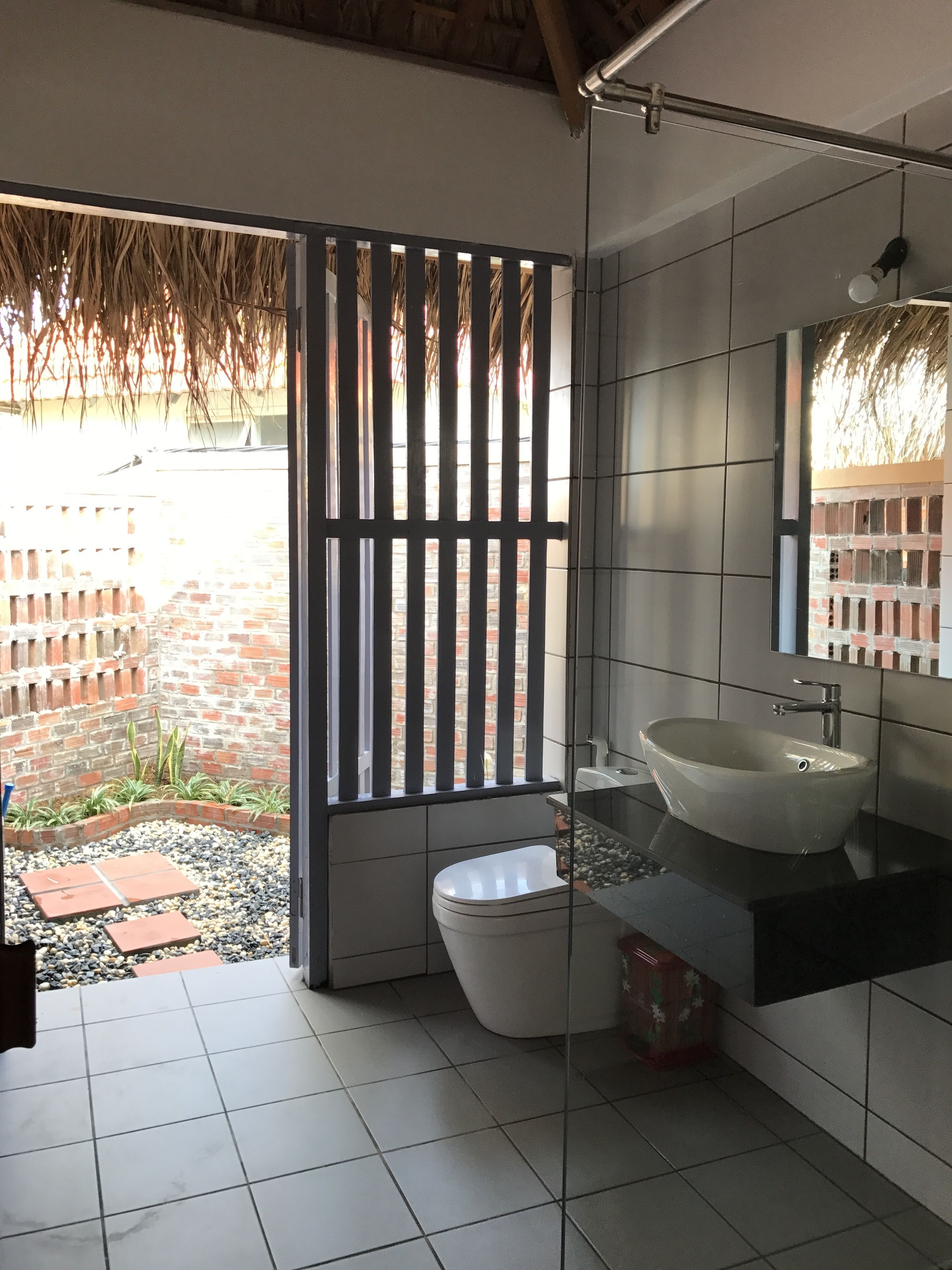 deluxe bungalow, terrace, beachfront | bathroom | shower, free toiletries, hair dryer, slippers