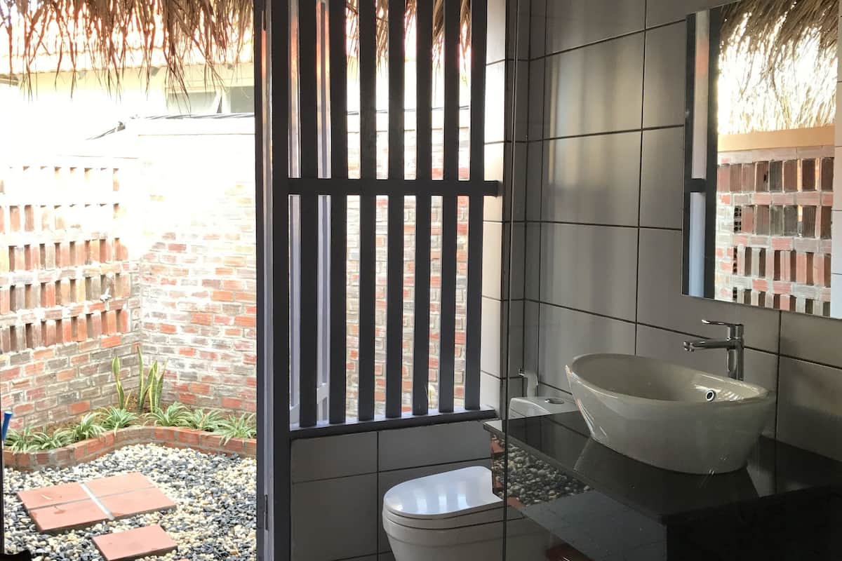 deluxe bungalow, terrace, beachfront | bathroom | shower, free toiletries, hair dryer, slippers