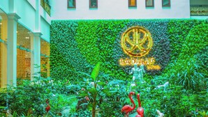 A lush indoor garden with a sign for La Dalat Hotel. - Ladalat Hotel (Lam Vien - Da Lat)