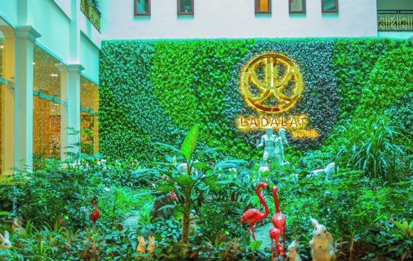 A lush indoor garden with a sign for La Dalat Hotel. - Ladalat Hotel (Lam Vien - Da Lat)