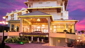 A multi-story hotel with a prominent sign reading "LADALAT" at the top. The building features a modern architectural design with balconies and a covered entrance area. - Ladalat Hotel (Lam Vien - Da Lat)