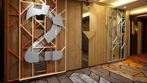 A hallway with geometric wall designs and patterned flooring. - ibis Styles Medan Pattimura (Medan)