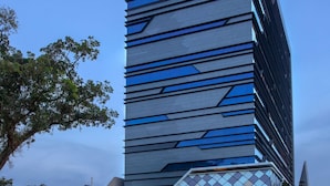 A modern building with a geometric facade and a glass entrance. - ibis Styles Medan Pattimura (Medan)