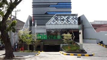 A modern building with a glass facade and a sign reading "bis Styles".
