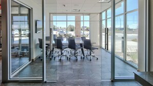 A modern conference room with glass walls, a large table, and several office chairs. - Fairfield Inn & Suites by Marriott Albuquerque North (Albuquerque)