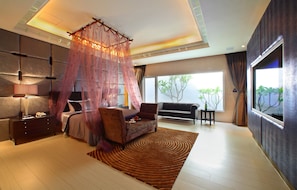 A modern bedroom with a bed, bedside table, and a large window. - Young Motel (Taoyuan City)