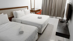 A hotel room with two beds, a TV, a desk, a chair, and a window with curtains. - T Hotel Anggerik (Alor Setar)