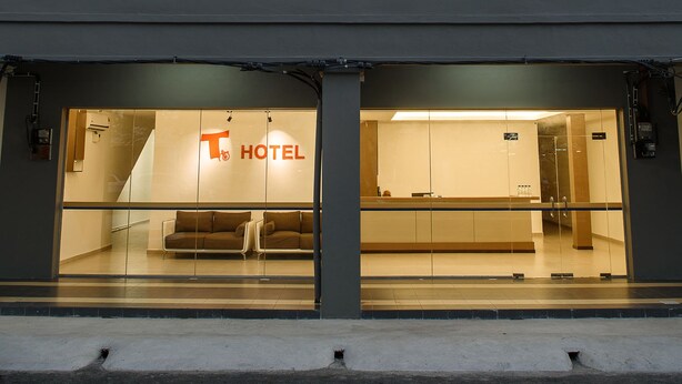 A hotel with a prominent 'T HOTEL' sign, large windows, and a modern facade. - T Hotel Anggerik (Alor Setar)