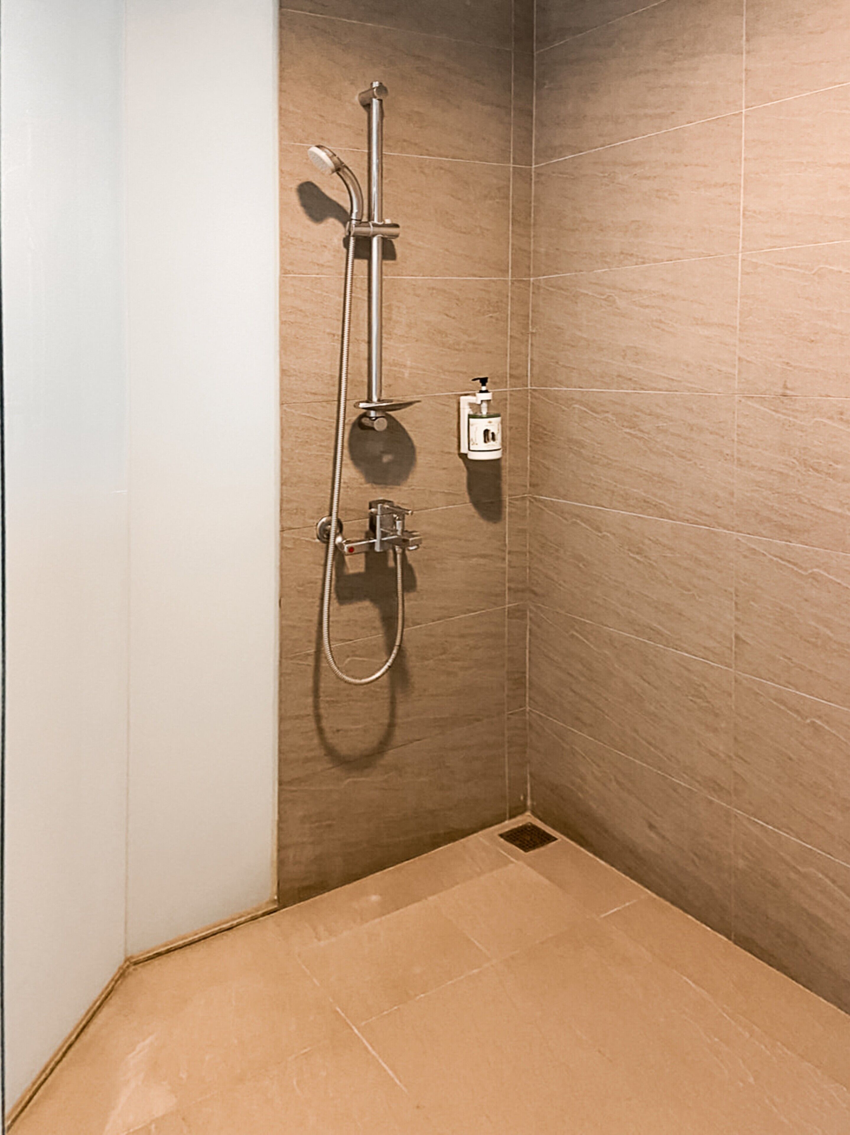 deluxe suite | bathroom | shower, rainfall showerhead, hair dryer, towels