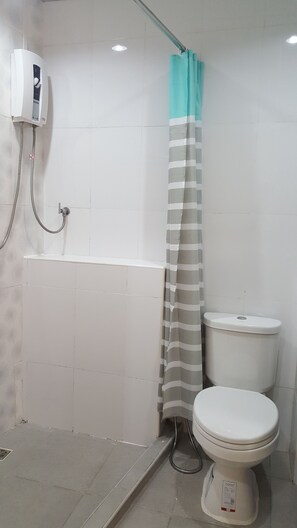 A bathroom with a shower, toilet, and a towel rack. - Double D Rooms & Cafe (Bangkok)