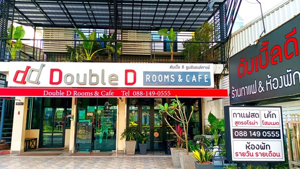 The exterior of Double D Rooms & Cafe with a tiled entrance and potted plants. - Double D Rooms & Cafe (Bangkok)