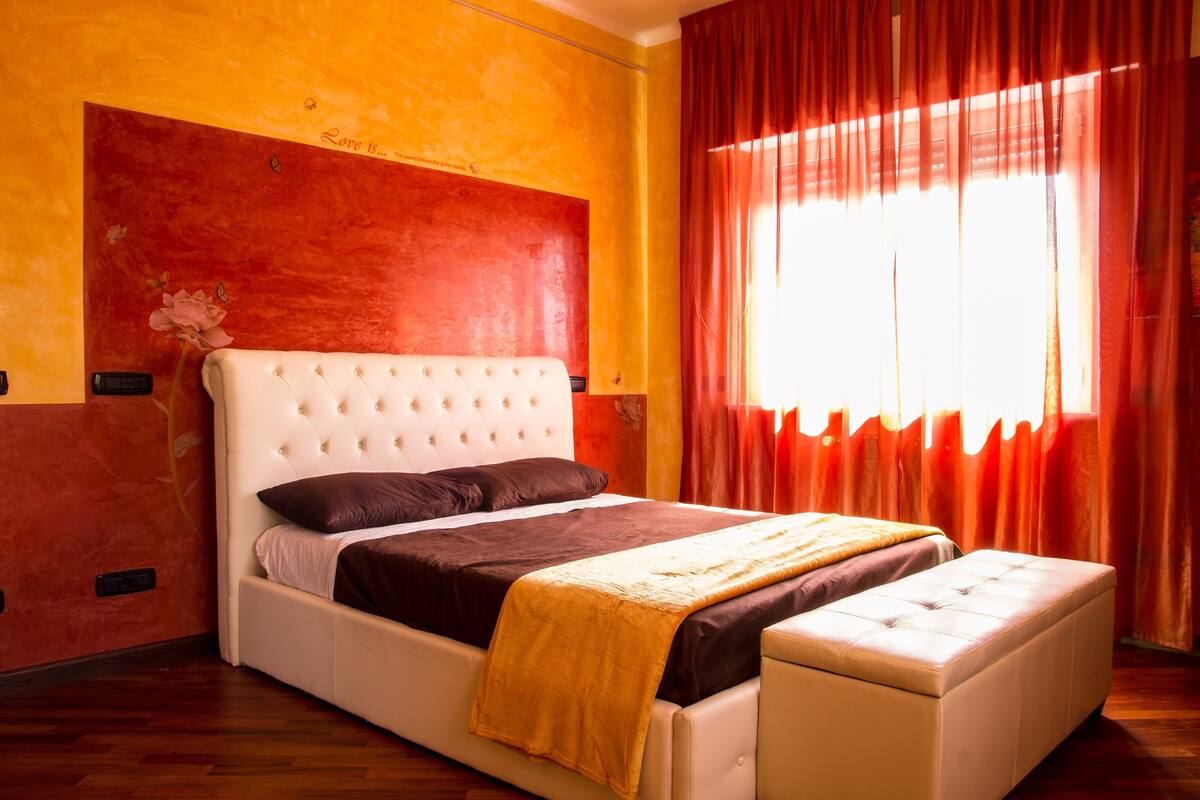 A bed with a white headboard, a brown mattress, and a yellow throw blanket.