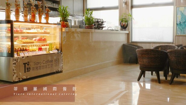 A Tiaro Coffee station with pastries and beverages, wicker chairs, and a large window with natural light. - Dar Lon Hotel (Hsinchu)