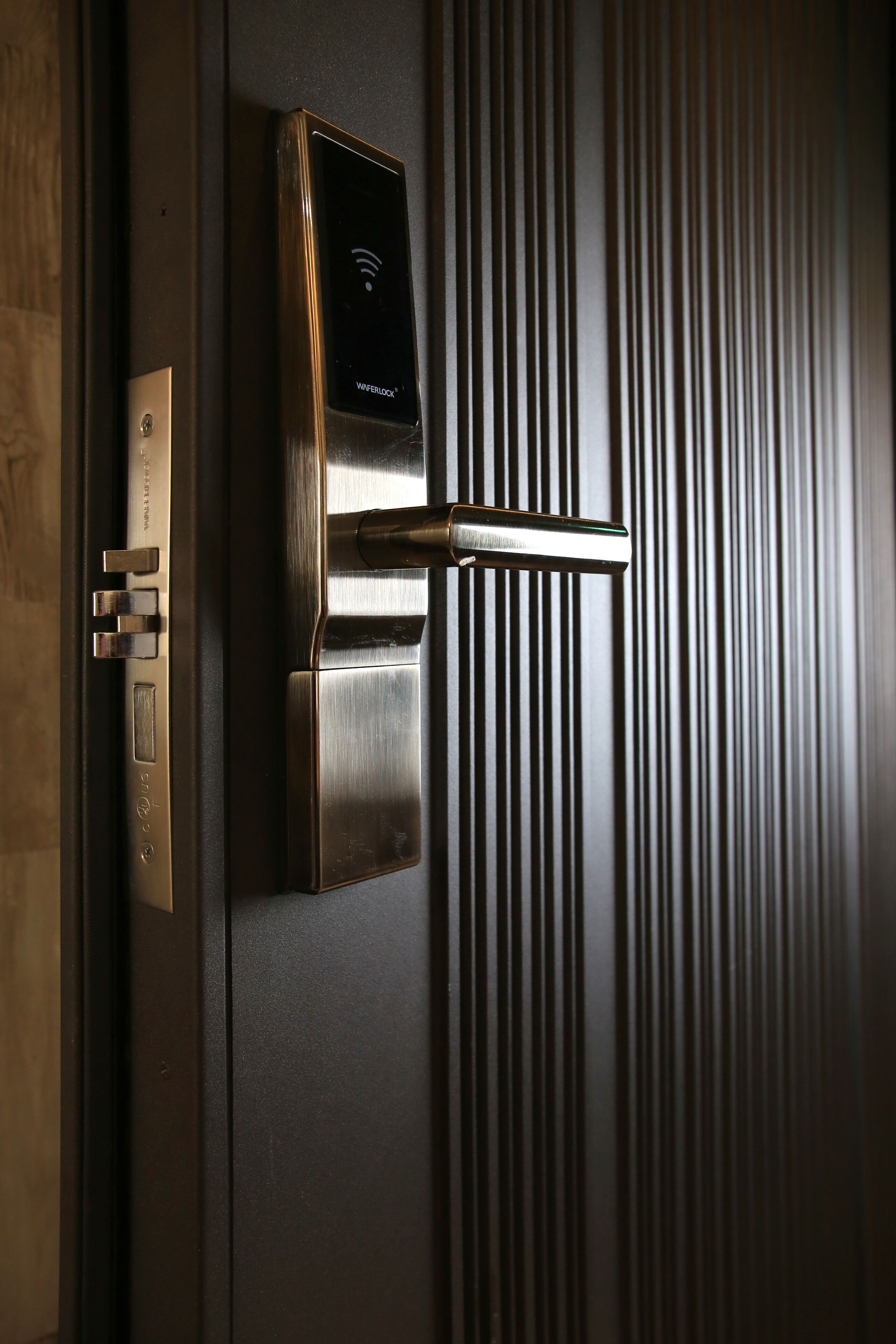 A modern door with a digital lock and a keyhole.