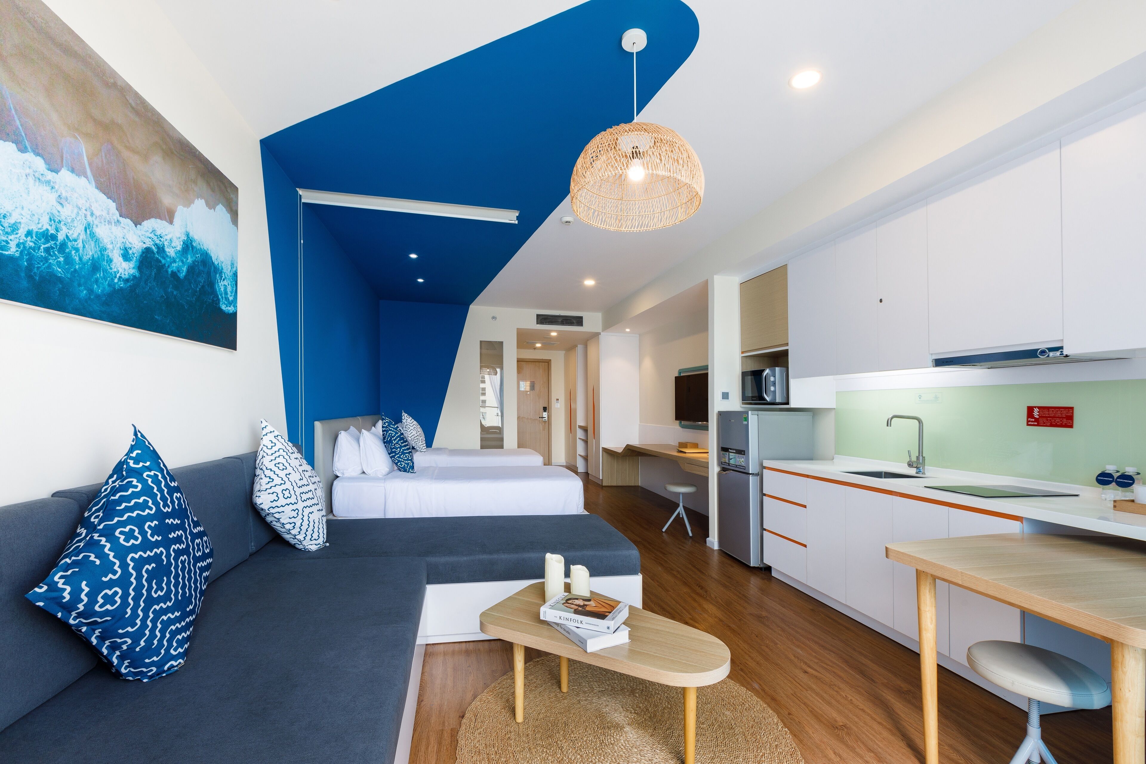 A modern apartment with a living area, kitchen, and dining space.