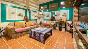 A cozy living room with a sofa, a coffee table, and a bookshelf. - Cat Sky Country Homestay (Sanxing)