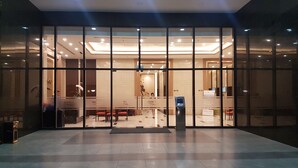 A hotel lobby with a reception desk, seating area, and a digital check-in kiosk. - Herla Central Saigon (Ho Chi Minh City)