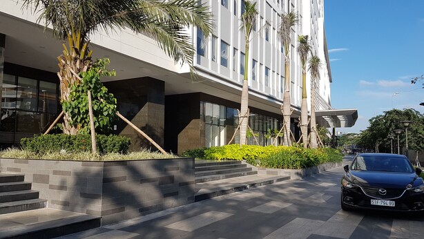 A modern building with a car parked in front. - Herla Central Saigon (Ho Chi Minh City)