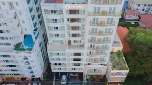 A multi-story hotel with balconies, a pool, and a sign reading "SEALIGHT HOTEL". - Le Soleil Hotel Nha Trang (Nha Trang)
