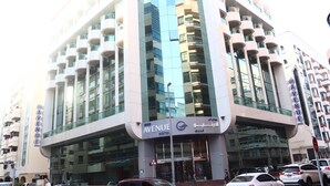 A modern hotel with a curved facade, large windows, and balconies. - GSS Avenue Hotel (Dubai)