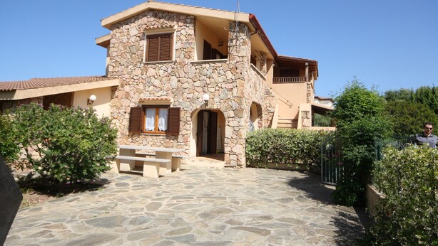 A stone house with a balcony, a stone staircase, and a paved entrance area. - Casa Nadia (San Teodoro)