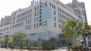 A multi-story building with a modern architectural design, featuring a prominent signage at the top. - GreenTree Alliance Suzhou Zhangjiagang Huachang Road Bus Station Hotel (Suzhou)